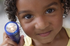 Mia Lindsey, 3, shines a flashlight she received at Tosa's Night Out on Aug. 3, 2010.